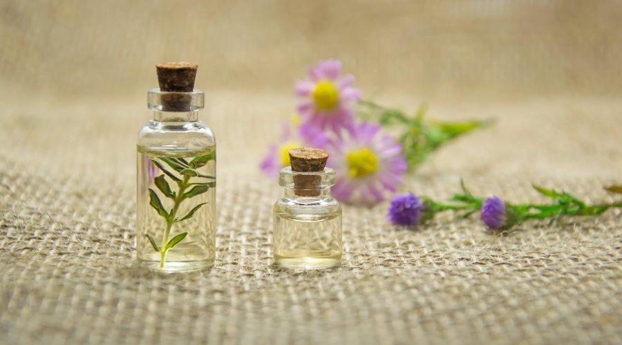 two clear glass bottles with liquids